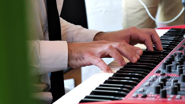 jazz festival
a close-up of the pianist's hands performing his part of the song
the pianist's fingers nimbly run over the keys