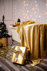 New Year's decoration of the room in golden color. The concept of the holiday and festive design. Home decor for the New Year.