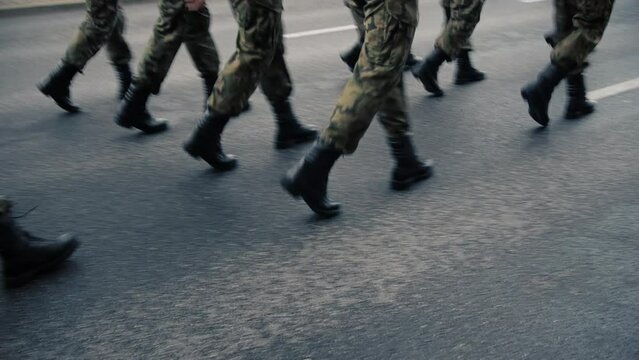 View of the marching soldiers' legs.  