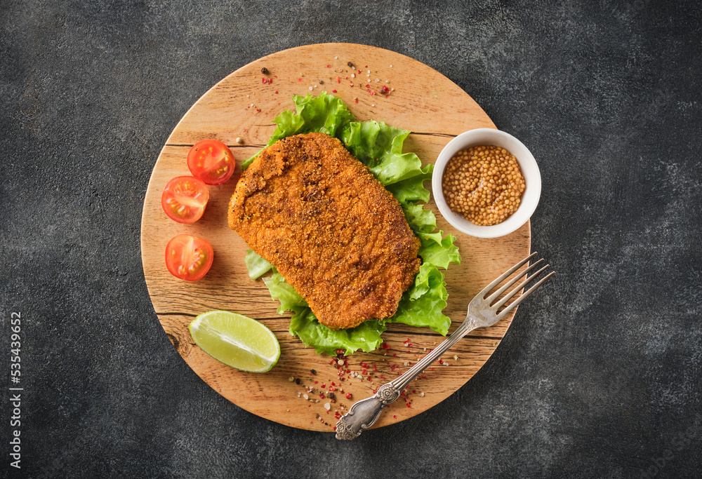 Wall mural pork cutlet with vegetables, top view.