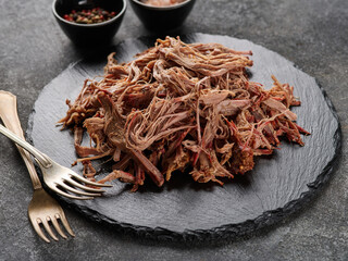 Traditional barbecue pulled pork. Slow cooked pulled pork shoulder. Juicy pork meat cooked in a smoker by low and slow