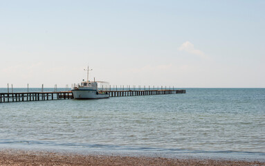 Photo seascape with a pier and a ship. Kherson region, the town of Skadovsk.