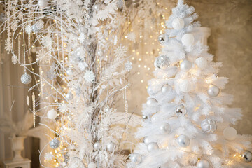 The interior of the house is decorated with a Christmas tree in anticipation of the holiday. A large bright room is decorated with decorations. New Year. Christmas decorations