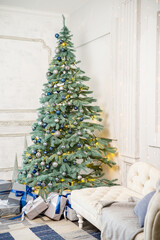 The guest room is decorated for Christmas, a tree with gifts and toys, Christmas balls