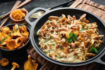 Mushroom dishes. Cooked chanterelle mushrooms in a cream sauce. Top view. Free space for text.