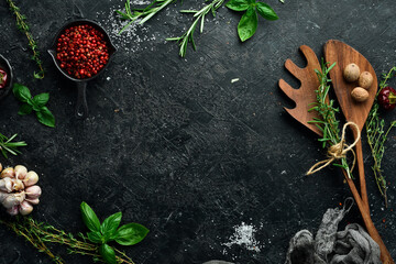 Cooking concept. Wooden kitchen utensils on a black stone table. Top view. Free space for your text.