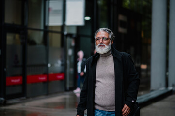 Portrait of a senior businessman outside of the office building