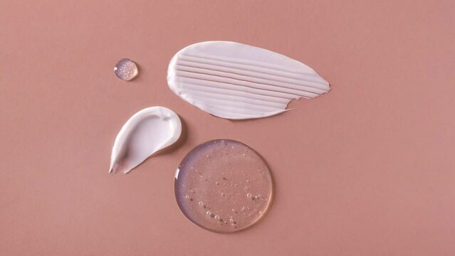 cosmetic smears of creamy texture on a pastel beige background