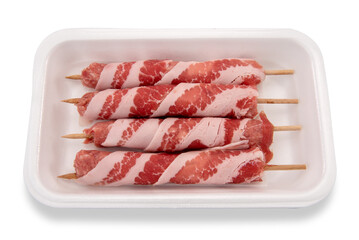 Pork and bacon rolls skewers in white food plastic tray for sale in supermarket isolated on white, clipping path