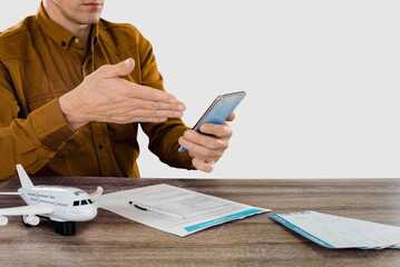Male tourist in airport filling travel insurance policy to prevent incidents during journey in the...