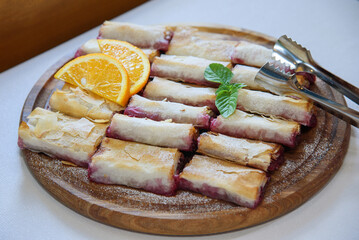 Fresh slice of cherry pie on white plate