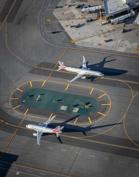 Vertical aerial view of two American Airlines planes taxing at Boston's Logan Airport