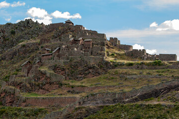 Fototapeta na wymiar The ancient ruins of Pisac in the Sacred Valley of the Incas in Peru. These Incan ruins, known as Inca Písac, lie atop a steep mountain.