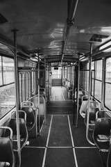 Vertical grayscale of the inside of an empty bus
