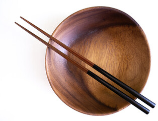Asian wooden bowl, wooden plate, with chopsticks and without on Abstract pastel colored paper,...