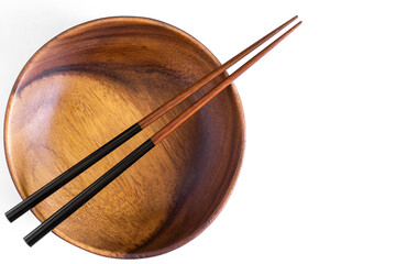 Asian wooden bowl, wooden plate, with chopsticks and without on Abstract pastel colored paper,...