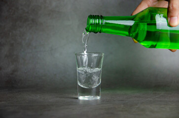soju is pouring on glass, selective focus