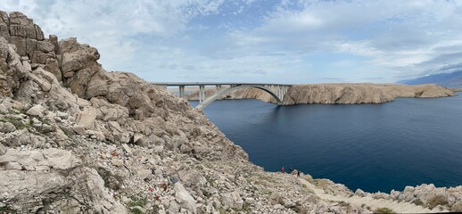 Aerial view of Paski bridge over lake surrounded by rocky beach