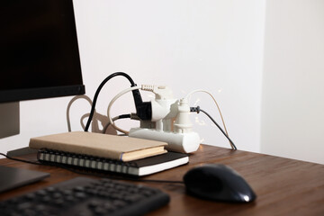 Inflamed plug in power strip indoors on wooden table. Electrical short circuit