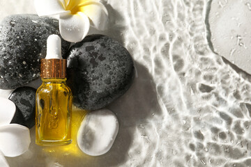 Fototapeta na wymiar Bottle of face serum and spa stones in water on light background, flat lay. Space for text