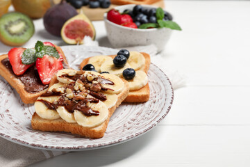 Different sweet delicious toasts on plate, closeup