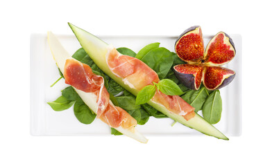 Plate with tasty melon, jamon, figs and spinach isolated on white, top view