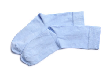 Pair of light blue socks on white background, top view
