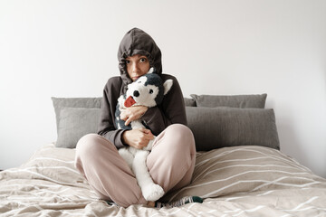 Young woman freezing and dressing up at cold home. Power energy crisis, economy inflation 