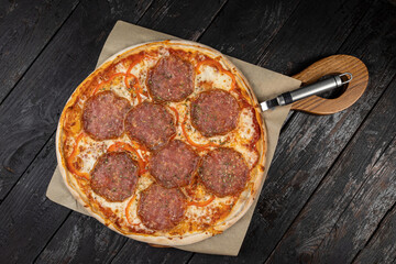 delicious pizza with cheese, greens, sauce in a restaurant
