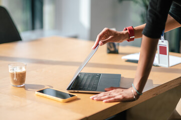 Businesswoman closing her lapop in the end of working day