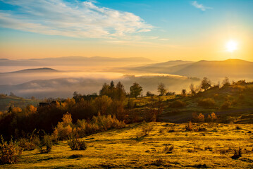 morning fog in the autumn landscape. countryside. fields and mountains in fog at sunrise