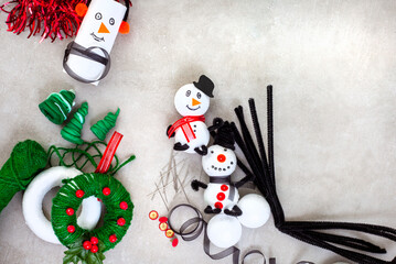 Kids Christmas crafts of snow man and wreath ornaments with polystyrene, string, pipe cleaners and more.