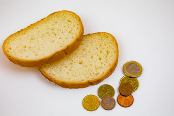 Two slices of bread and euro coins on a white background