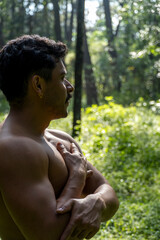 man seen up close, without shirt doing stretches on yoga mat, exercise, latin america