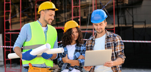 Architects discussing project of building at construction site