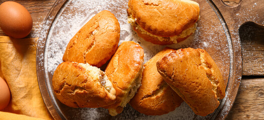 Tasty sochniki with cottage cheese on wooden background, top view