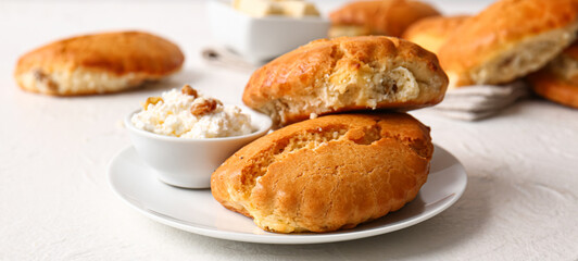 Plate of tasty sochniki with cottage cheese on white background