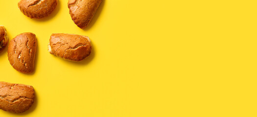 Tasty sochniki with cottage cheese on yellow background with space for text