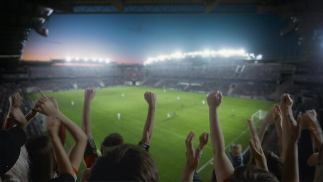 Establishing Shot of Fans Cheer for Their Team on a Stadium During Soccer Championship Match. Teams Play, Crowds of Fans Scream and Celebrate Victtory, Goal. Football Cup Tournament. Static Wide Shot