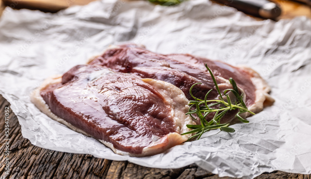 Wall mural duck breast with rosemary in food paper ready for baking