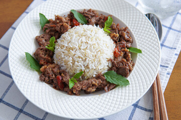 Thai food stir-fried beef spicy and basil served with brown rice
