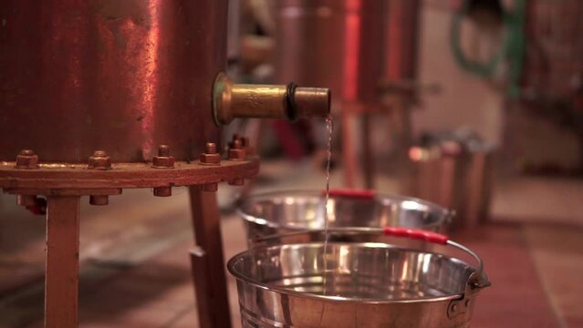 Making Greek Tsipouro, Ouzo, Cauldron Boiling Grapes to Produce Tsipouro Drink, 4K Handheld Footage