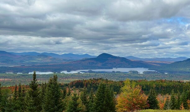 Aerial View Of Autumn Trees Near A Lake And Mountains In Jackman, Maine