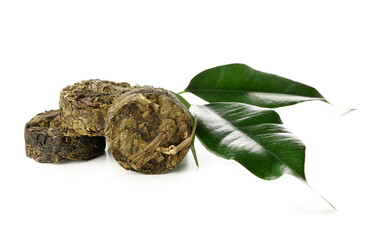 Dry pressed puer tea with leaves on white background