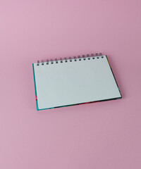 A blank sheet of spiral notebook in close-up on a white background.