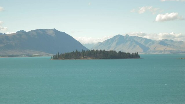Lake Tekapo with its tree-filled island in the middle, in New Zealand