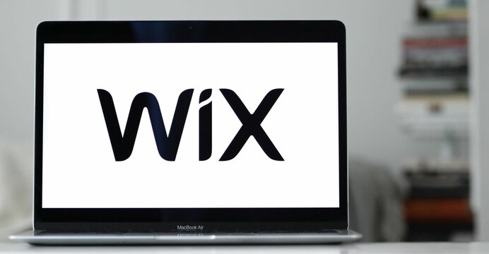 Logo of the Wix software company visible on a laptop computer on a blurred background