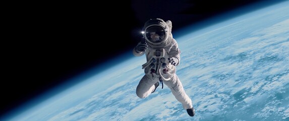 Female astronaut having a video call on her phone while performing space walk in open space, Earth in the background