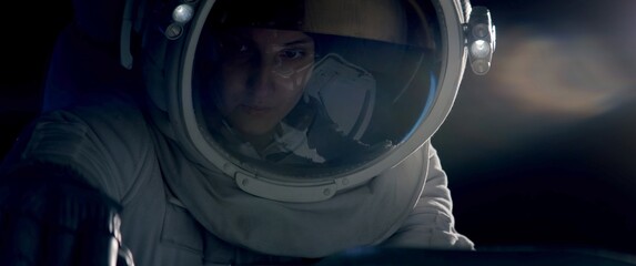 Portrait of female astronaut performing spacewalk, working on a outer part of a space craft. Space exploration, Mars mission