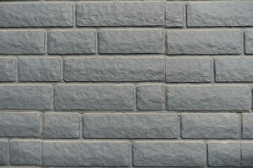 Close shot of dusty black painted brick veneer wall